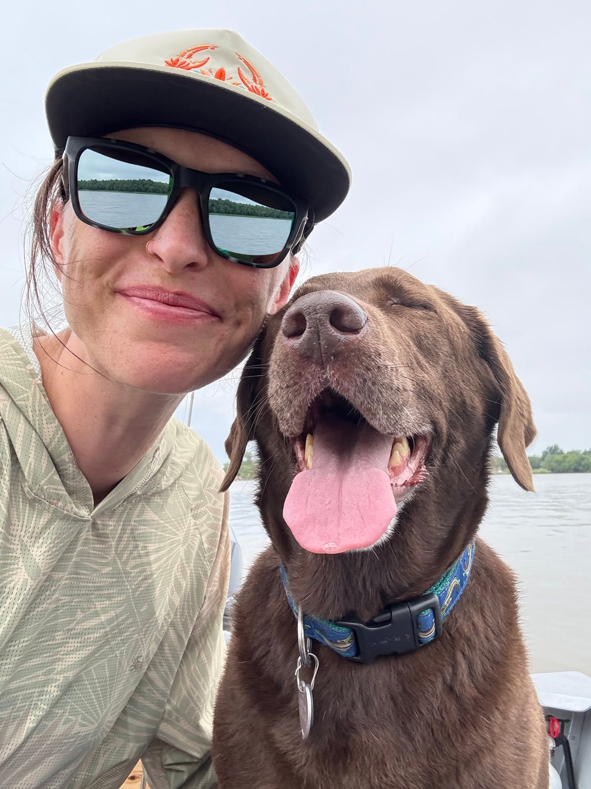 Nicole smiling outdoors with her dog, Aspen.
